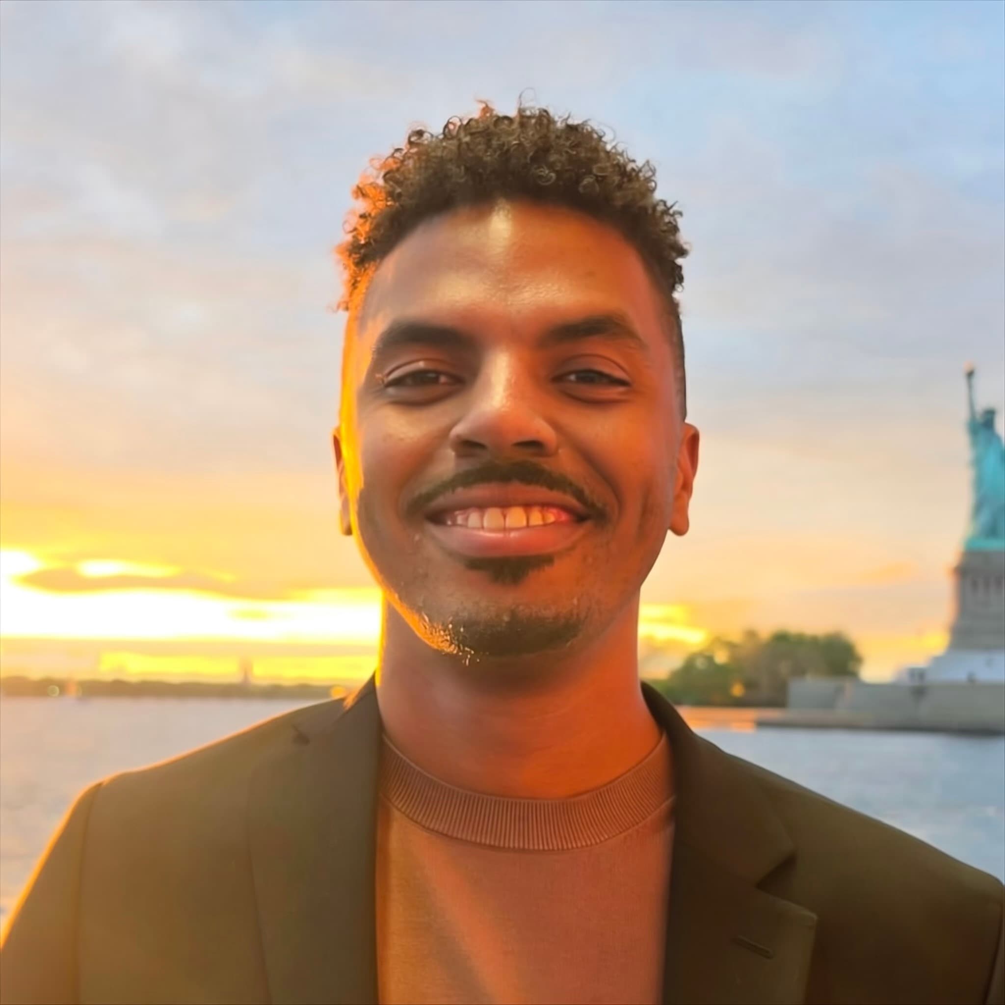 Moises at sunset near the Statue of Liberty
